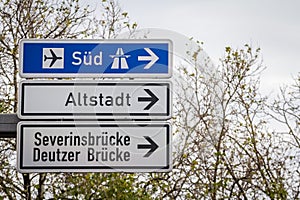 Selective blur on german roadsign in Cologne, Germany, directing to autobahn motorway heading south (Sud in German) & local road