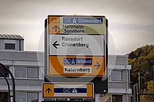 Selective blur on a german roadsign in Wuppertal, Germany, indicating directions to autobahn motorway to Dortmund & Dusseldorf &