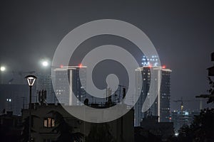 Selective blur on an old decaying building facing modern skyscraper towers in a redevolpment project of Belgrade, Serbia