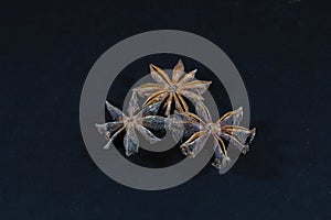Selective blur on star anise, three stars, isolated on a black background. Anise, or aniseed, is a spice, the flowering plant of