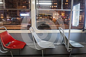 Selective blur on three empty plastic seats in an old vintage tram in belgrade, serbia, at night, with a speed blur in background