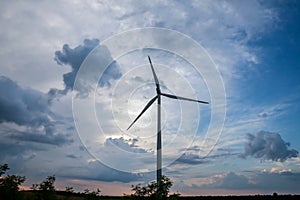 Selective blur on a windmills in the fields of Voivodina, in Serbia, during a sunny night, at dusk.