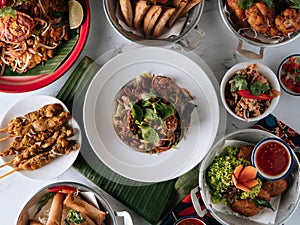 selective choice food table Shell Crab noodle, Chicken Satay, Spring Roll, Curry Samosa, fish cake, Folks Drumlet, Pork Jar Salad