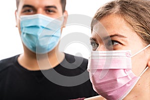 Selective close-up of girlfriend wearing pink mask and boyfriend