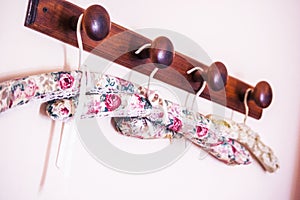 Selective closeup shot flower patterned clothes hangers on a brown wooden rod
