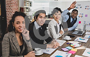 Selective focus on African american business men raising their hands to inquire about a business meeting and attendees of