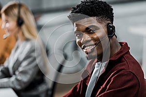 Selective focus of african american call center operator looking at camera