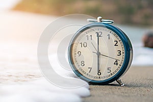 Selective focus of alarm clock with nature background