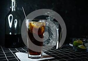 selective focus, alcoholic whiskey cocktail with Cola and lime