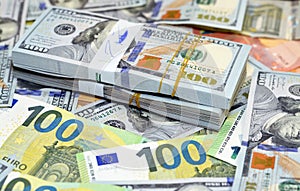 Selective focus of American money banknote bills with European cash money banknotes, stacks of USA and Europe money