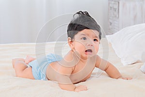 Selective focus Asian newborn baby crying after wake up in morning, adorable infant unhappy feel uncomfortable or hungry, toddler