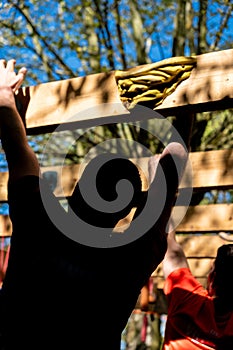 selective focus, athletes hands at a hanging obstacle at an obstacle course race, OCR competition