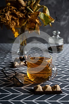 selective focus, autumn still life. Mug of hot tea with sweets