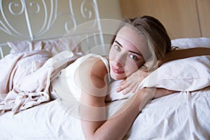 Selective focus Awakened young woman lies in bed in the morning