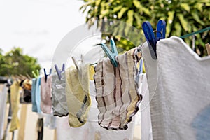 Selective focus on Baby laundry hanging on a clothes line