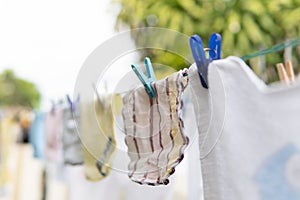 Selective focus on Baby laundry hanging on a clothes line