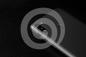 Selective focus on back of new smartphone Samsung Galaxy M11 triple camera and fingerprint sensor. Bucharest, Romania, 2021