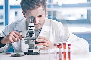 selective focus of bearded biochemist looking