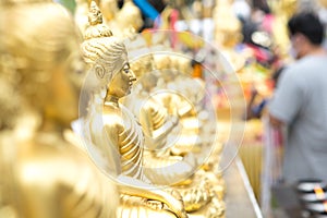 Selective focus of beautiful golden Buddha statues of Buddhism  at temple in Thailand