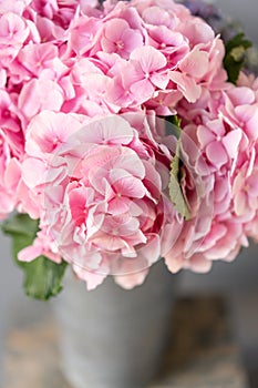 Selective focus. beautiful hydrangea flowers in a vase on a table . Bouquet of light pink flower. Decoration of home