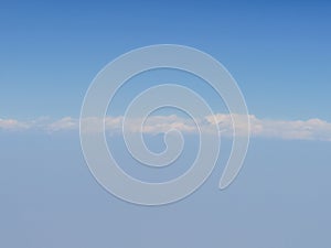 Selective focus blue sky and clouds from airplane window. photo