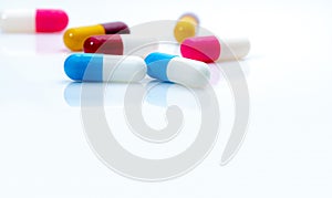 Selective focus on blue-white antibiotic capsule pills on white background. Prescription drugs. Colorful capsule pills. Antibiotic