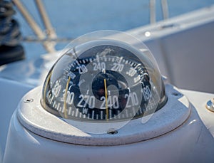 Selective focus of a boat compass on a sailboat