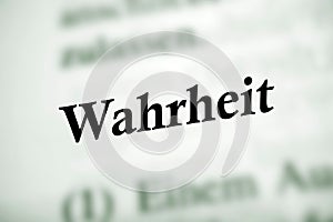 Selective focus from the book page of the word 'Wahrheit' translated as