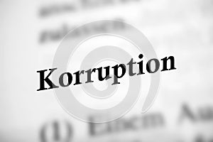 Selective focus from the book page of the word 'Korruption' translated as Corruption photo