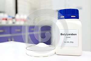 Selective focus of a bottle of butylparaben paraben pure chemical compound used as preservative in cosmetics and pharmaceutical photo
