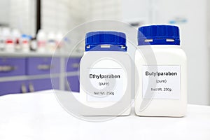 Selective focus of a bottle of ethylparaben and butylparaben parabens pure chemical compound used as preservative in cosmetics photo