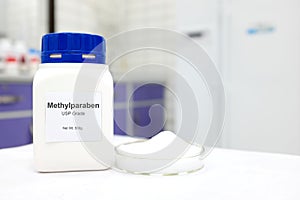 Selective focus of a bottle of Methylparaben paraben pure chemical compound used as preservative in cosmetics and pharmaceutical photo