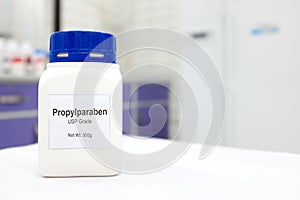 Selective focus of a bottle of Propylparaben paraben pure chemical compound used as preservative in cosmetics and pharmaceutical