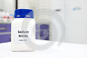 Selective focus of a bottle of sodium nitrite preservative chemical compound.