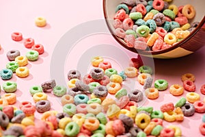 Selective focus of bright colorful breakfast cereal scattered from bowl