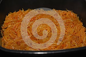 Selective focus of Browned in Butter sweet Egyptian vermicelli cooked with water and sugar in a cooking pot,.