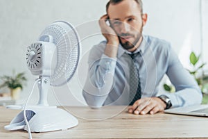 selective focus of businessman in office with white