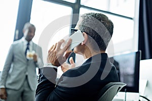 selective focus of businessman talking on smartphone