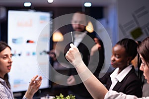 Selective focus of businesswoman leder sitting at desk analyzing marketing presentation discussing financial graps