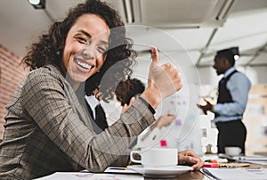 Selective focus on businesswomen Thumbs up It represents a happy and fun atmosphere in a business meeting room. Full of smile In