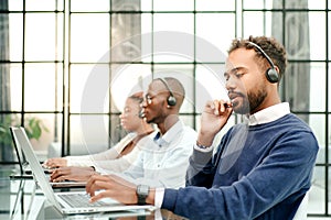 call center operator in headset working in office.