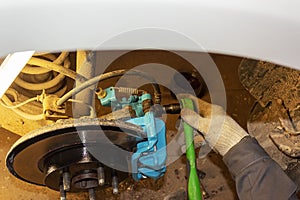 Selective focus of car brake disc for repair. Repair of car brakes in the garage.