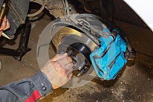 Selective focus of car brake disc for repair. Repair of car brakes in the garage.