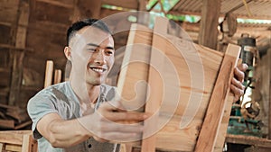 Selective focus of carpenters smile when holding wooden planks