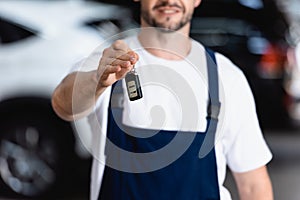 Selective focus of cheerful mechanic in