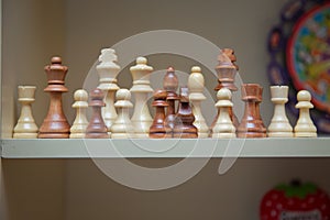 Selective focus of chess on chess board and beige background