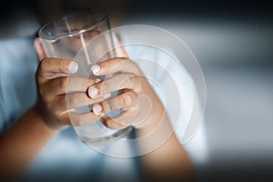 Selective focus of child holding empty drinking glass