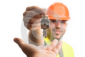 Selective focus close-up builder man giving house keys