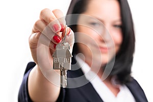 Selective focus close-up of female agent presenting house keys