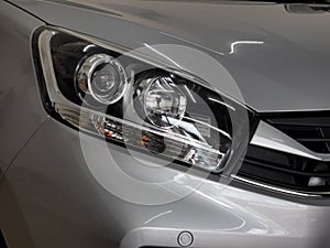 Selective focus close up image with noise effect of car head lamp.